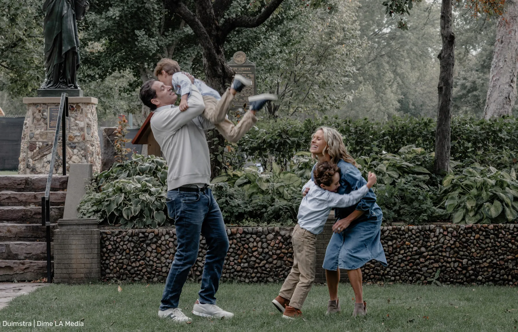 Dad swinging the kids while mom laughs, Sioux Falls family photography