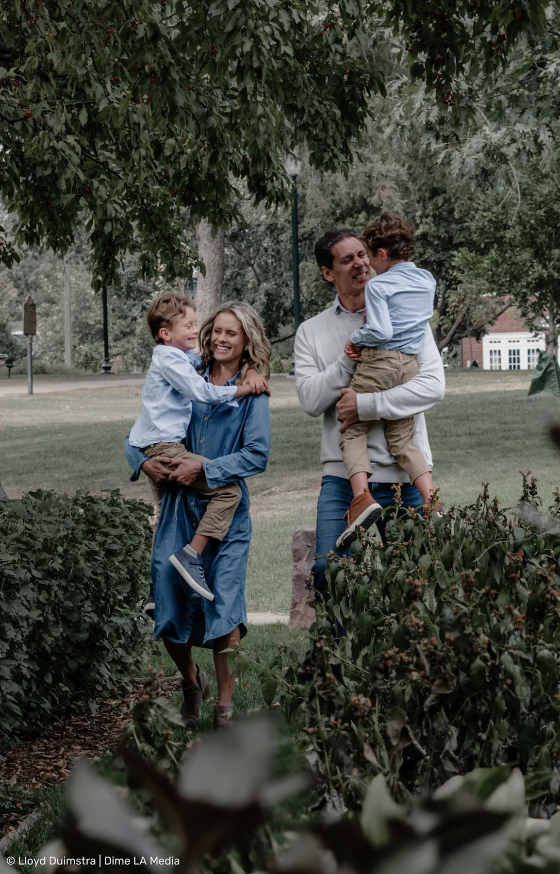 Full-family embrace at the end of a park session