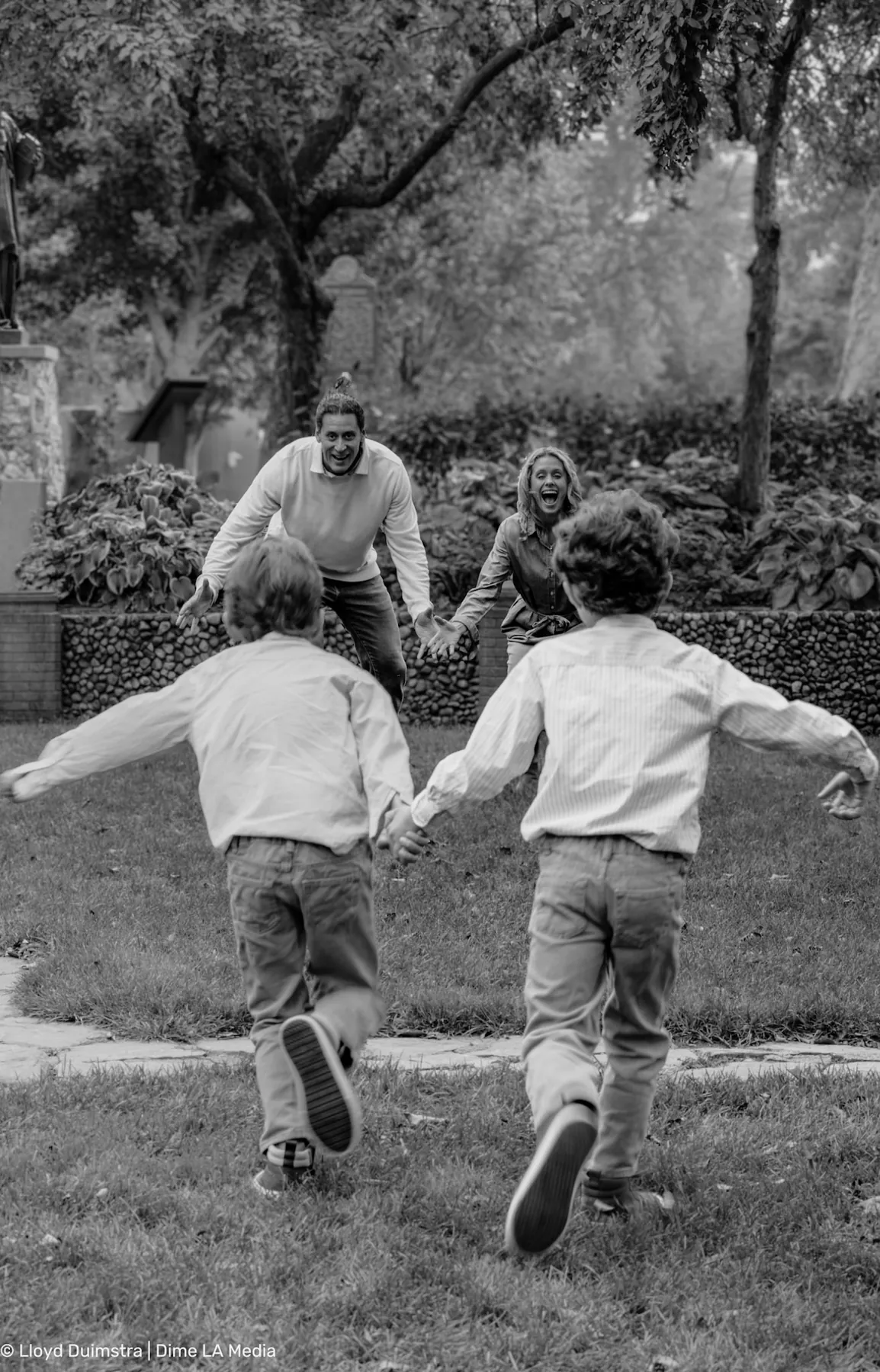 Black and white photo of the family running hand in hand