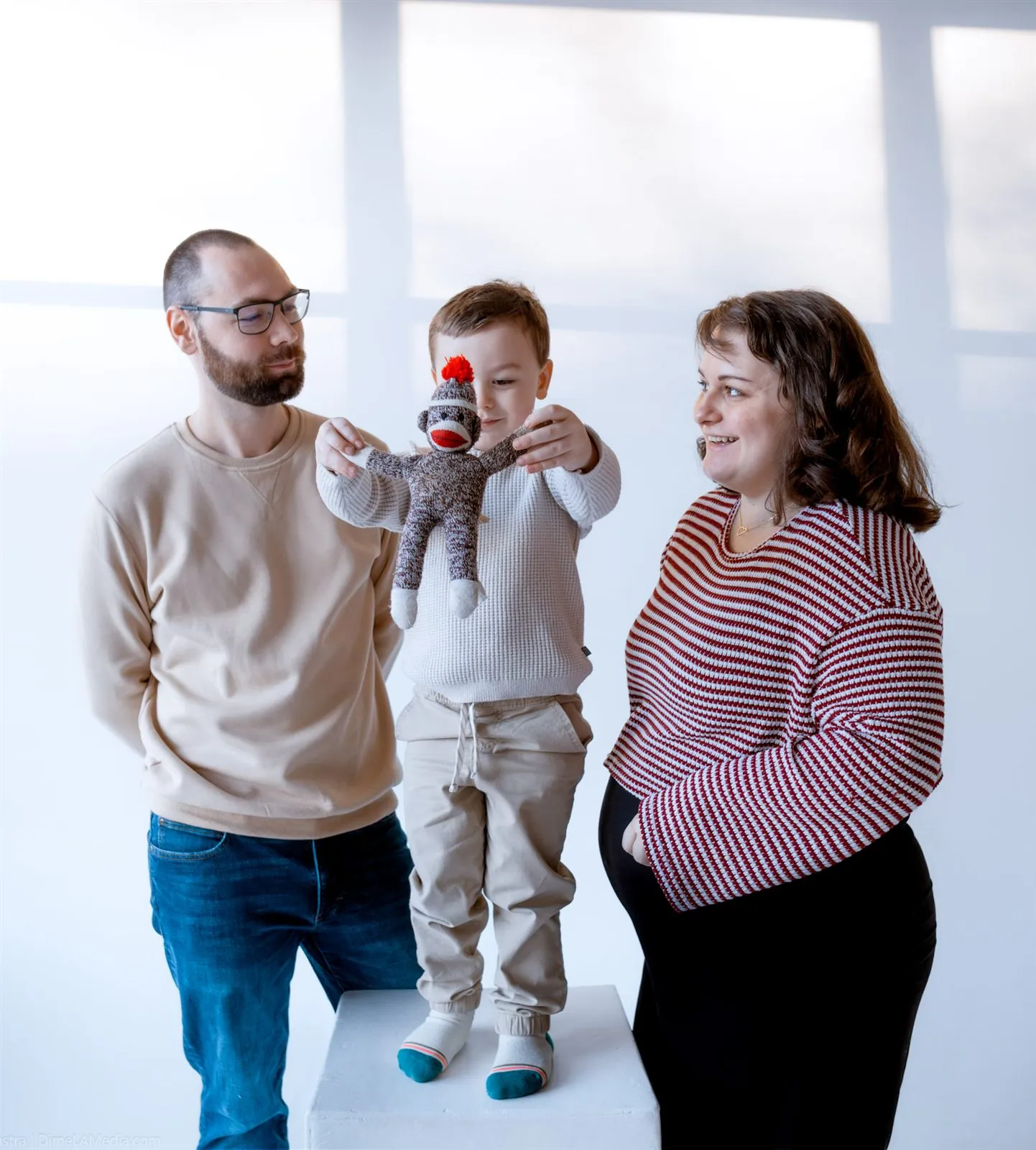 Family maternity portrait with a sock monkey for baby brother