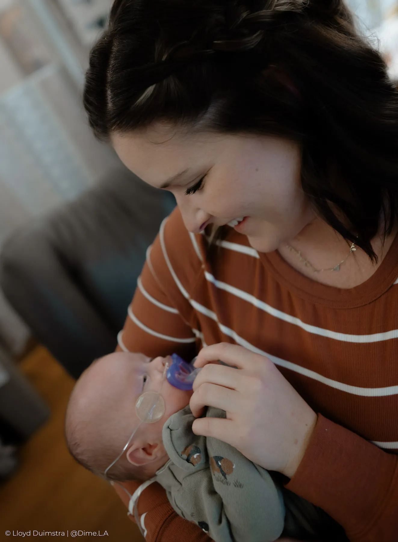 Mom smiling down at her newborn son