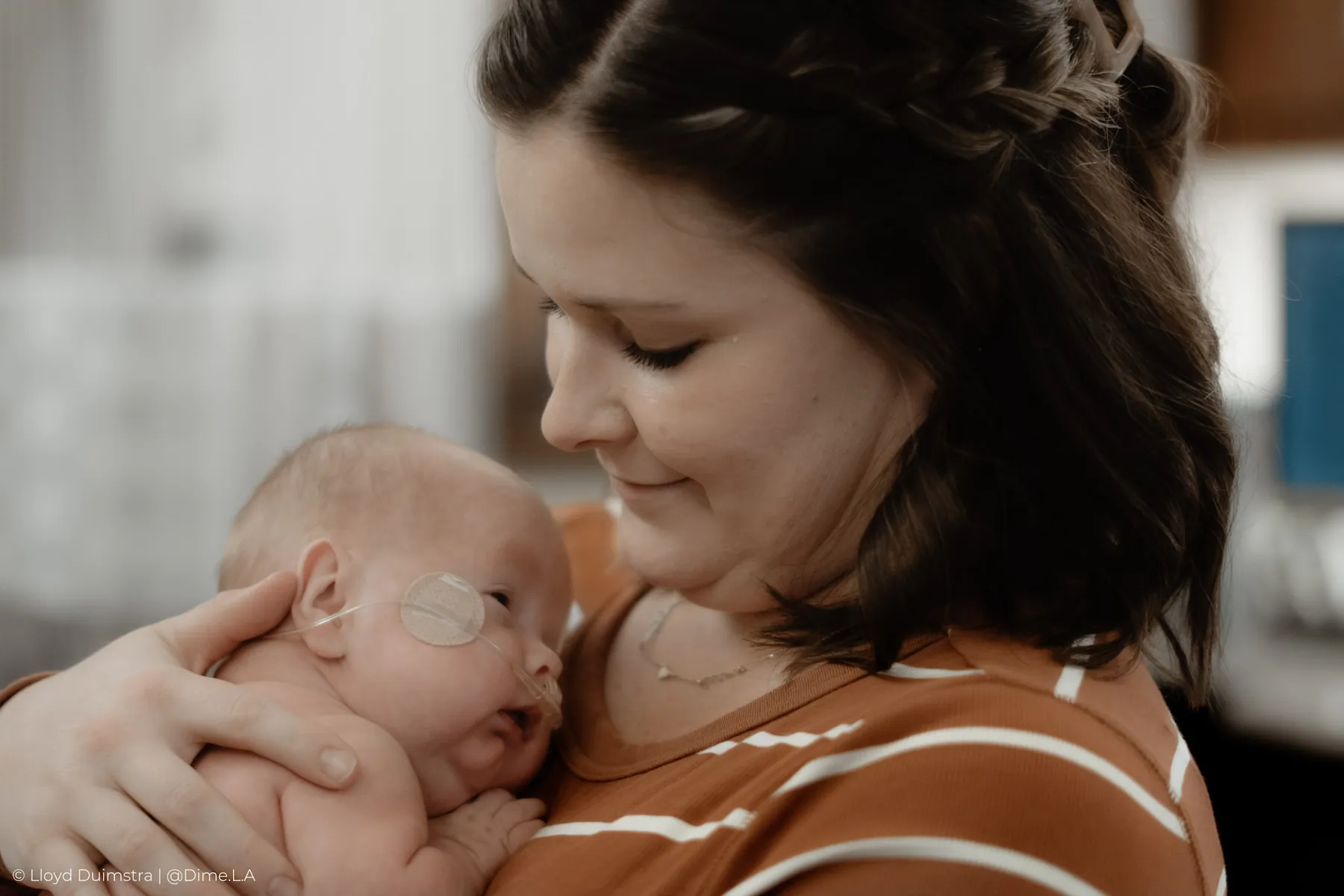 Dad holding his newborn to his chest, newborn session