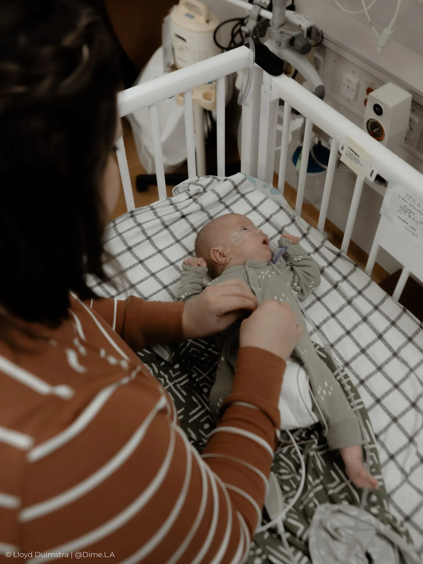 Newborn resting in his crib between feedings, NICU
