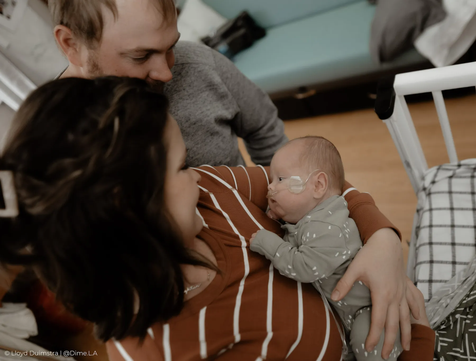 Parents sharing a quiet moment with their son in the NICU