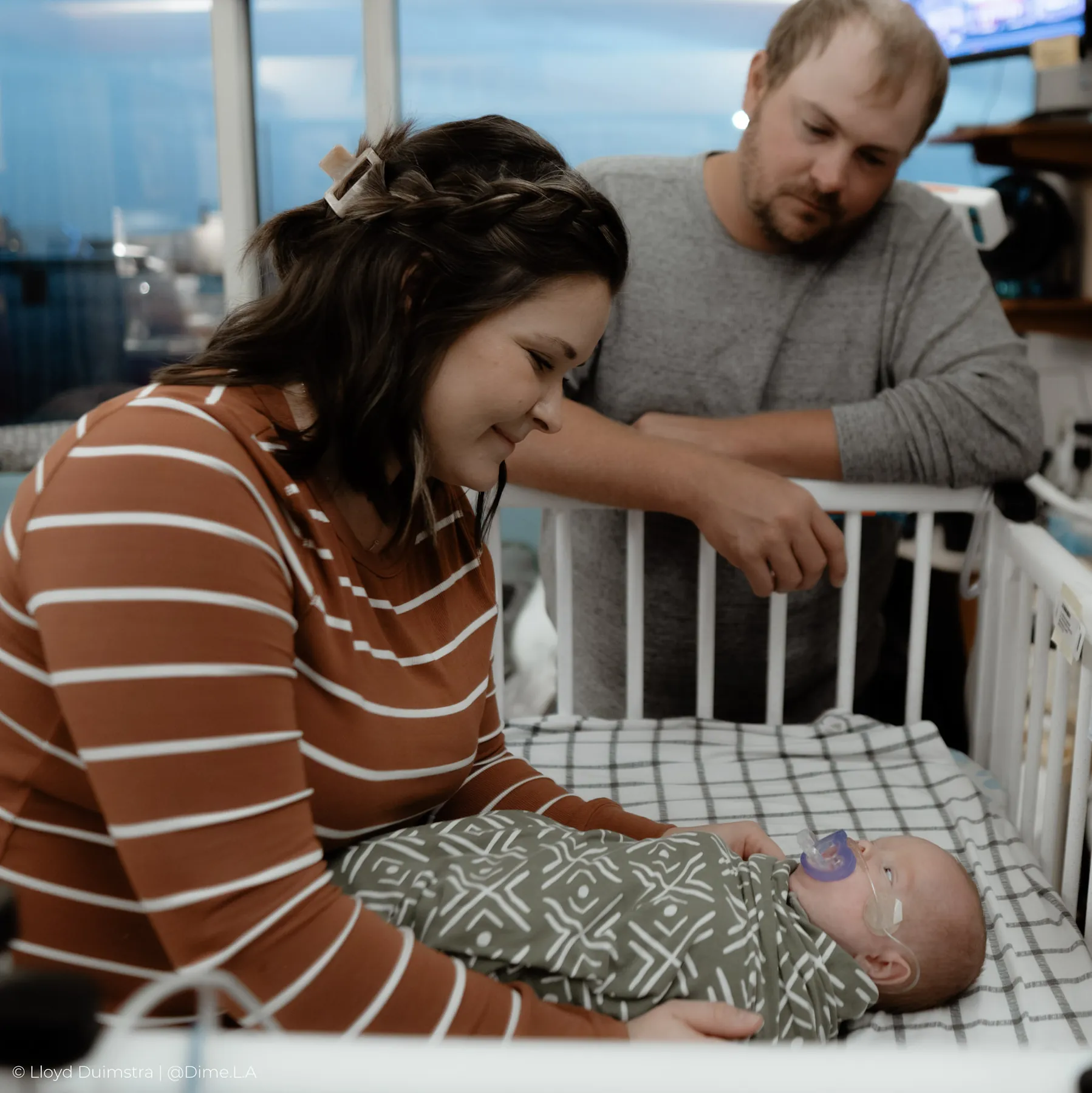 Mom and dad tucking their son in for the night at the NICU