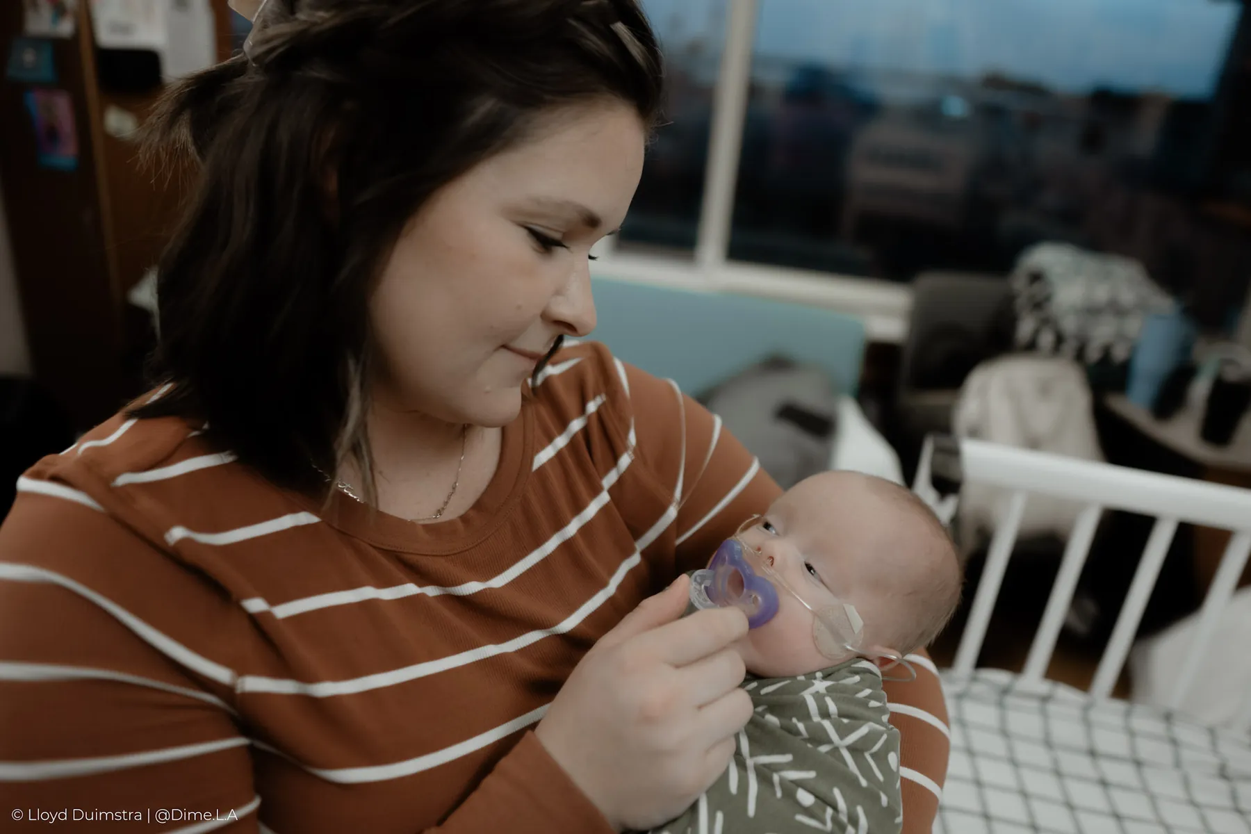 Mom soothing her newborn with his pacifier