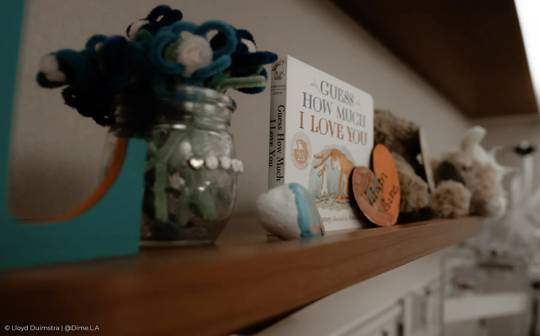 Flowers and keepsakes on the nursery shelf