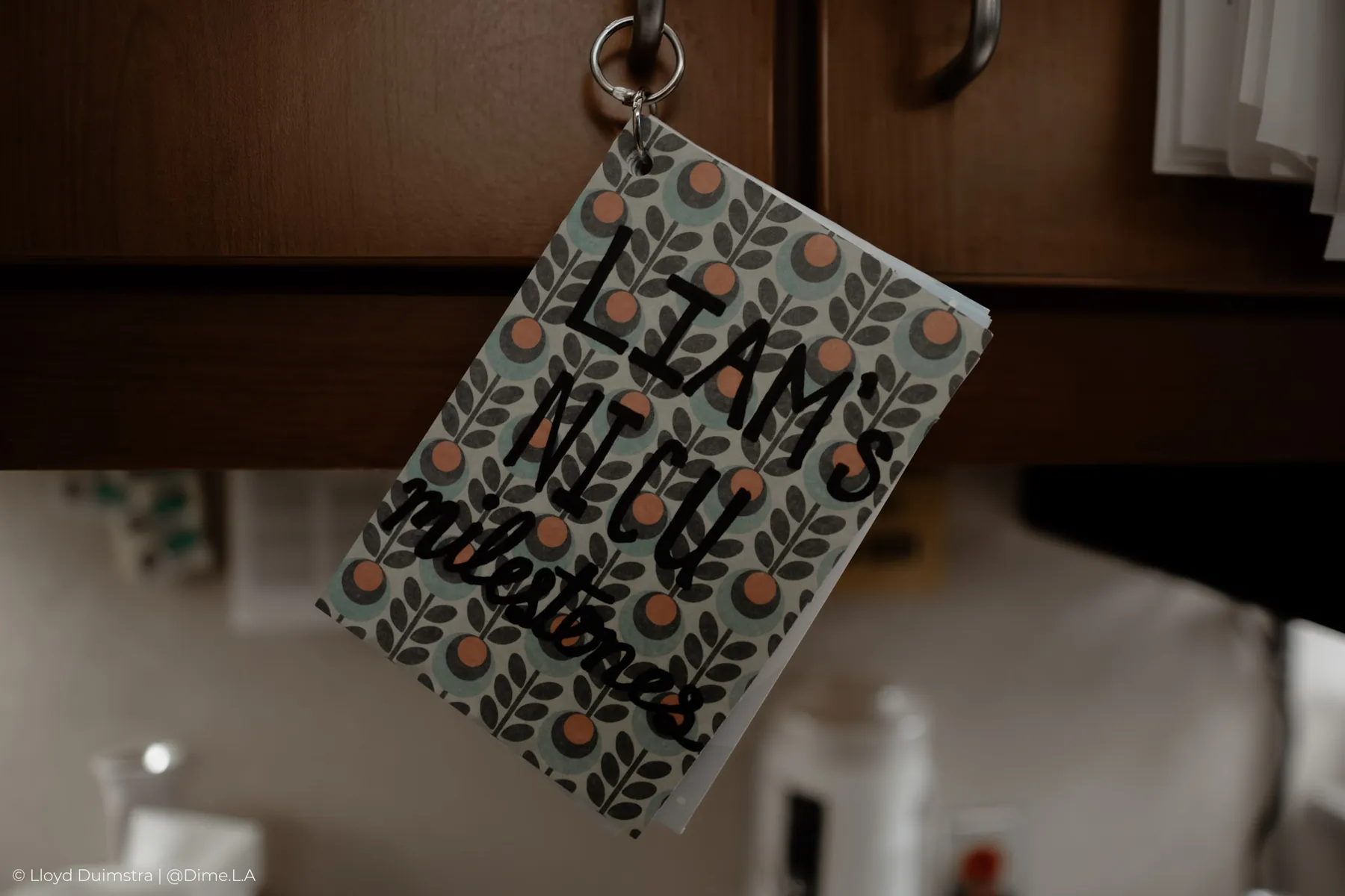 Liam’s milestone card hanging in the NICU nursery