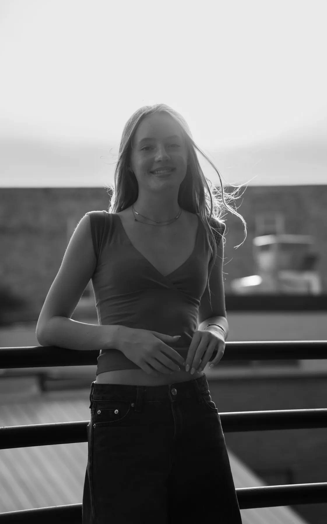 High key black and white portrait of Scout laughing on a downtown street