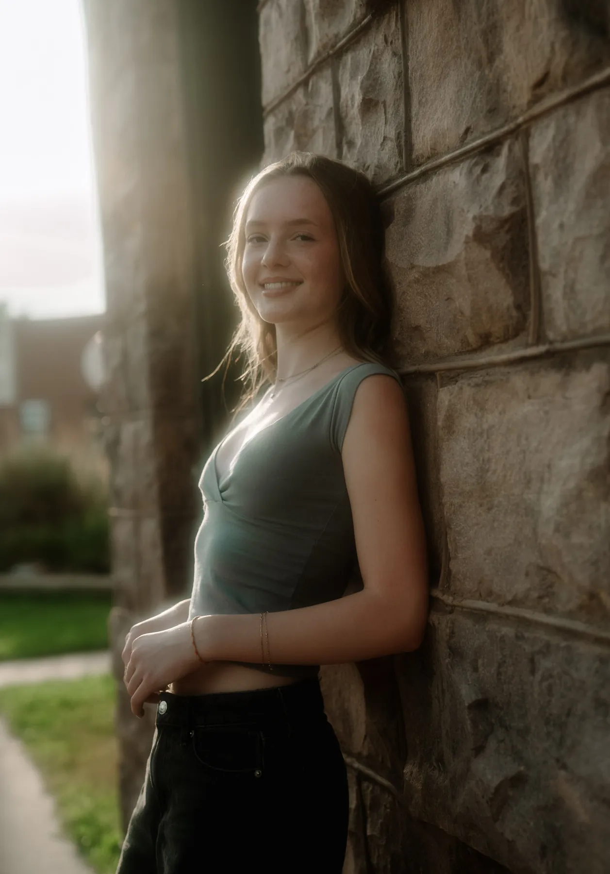 Scout backlit against a stone column at golden hour, Sioux Falls senior session