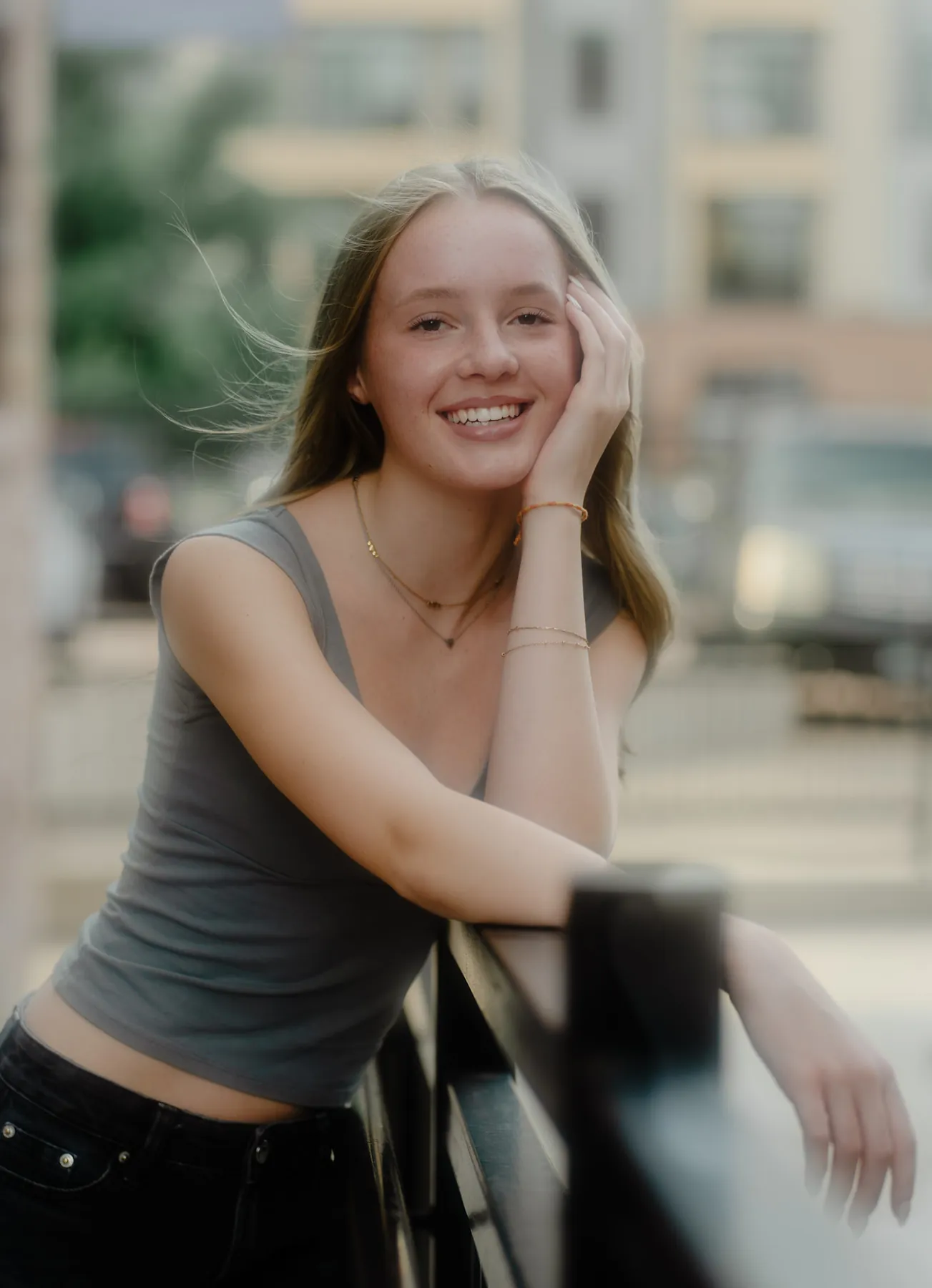 Candid laugh from Scout at a downtown Sioux Falls railing, late summer light