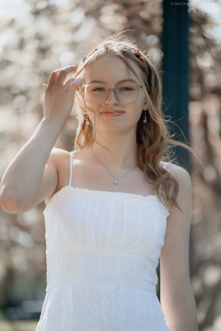 Syd Patzwald backlit senior portrait in spring blossoms