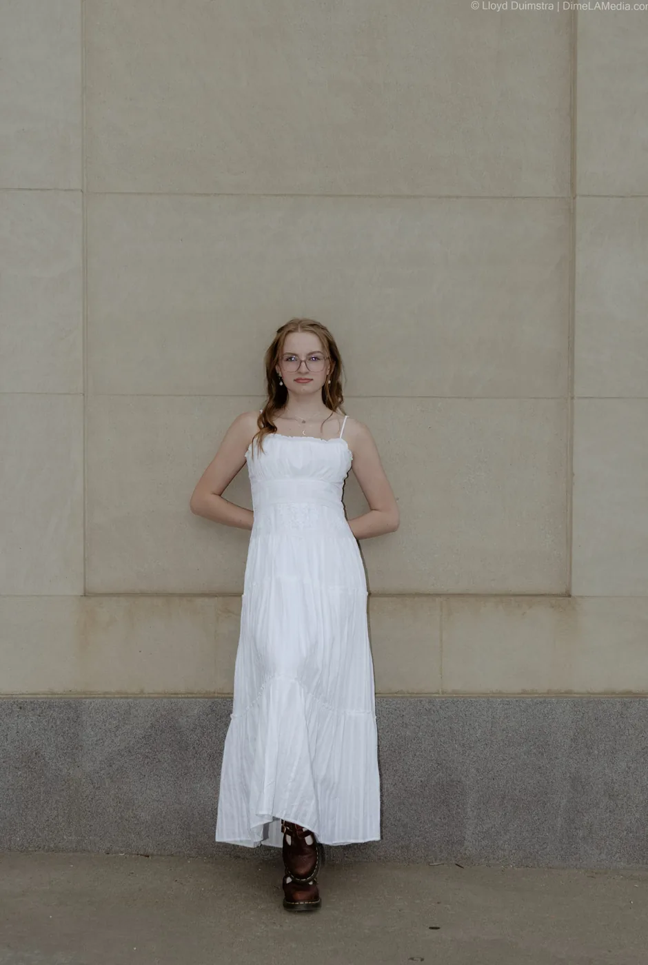 Syd Patzwald minimalist senior portrait against a stone wall