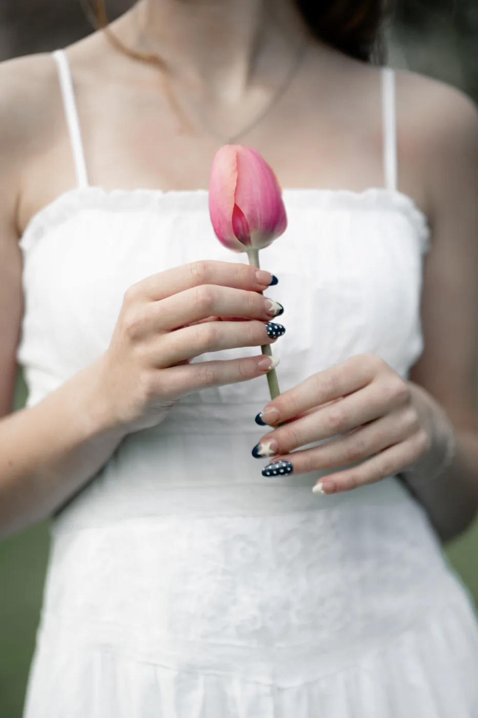 Detail photograph of nail art and a tulip from Syd Patzwald's senior session