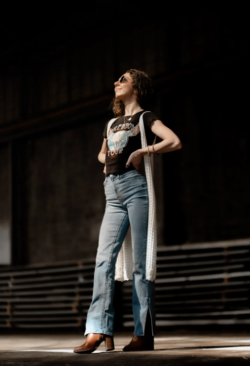 Full-length portrait in a dramatic shaft of warehouse light
