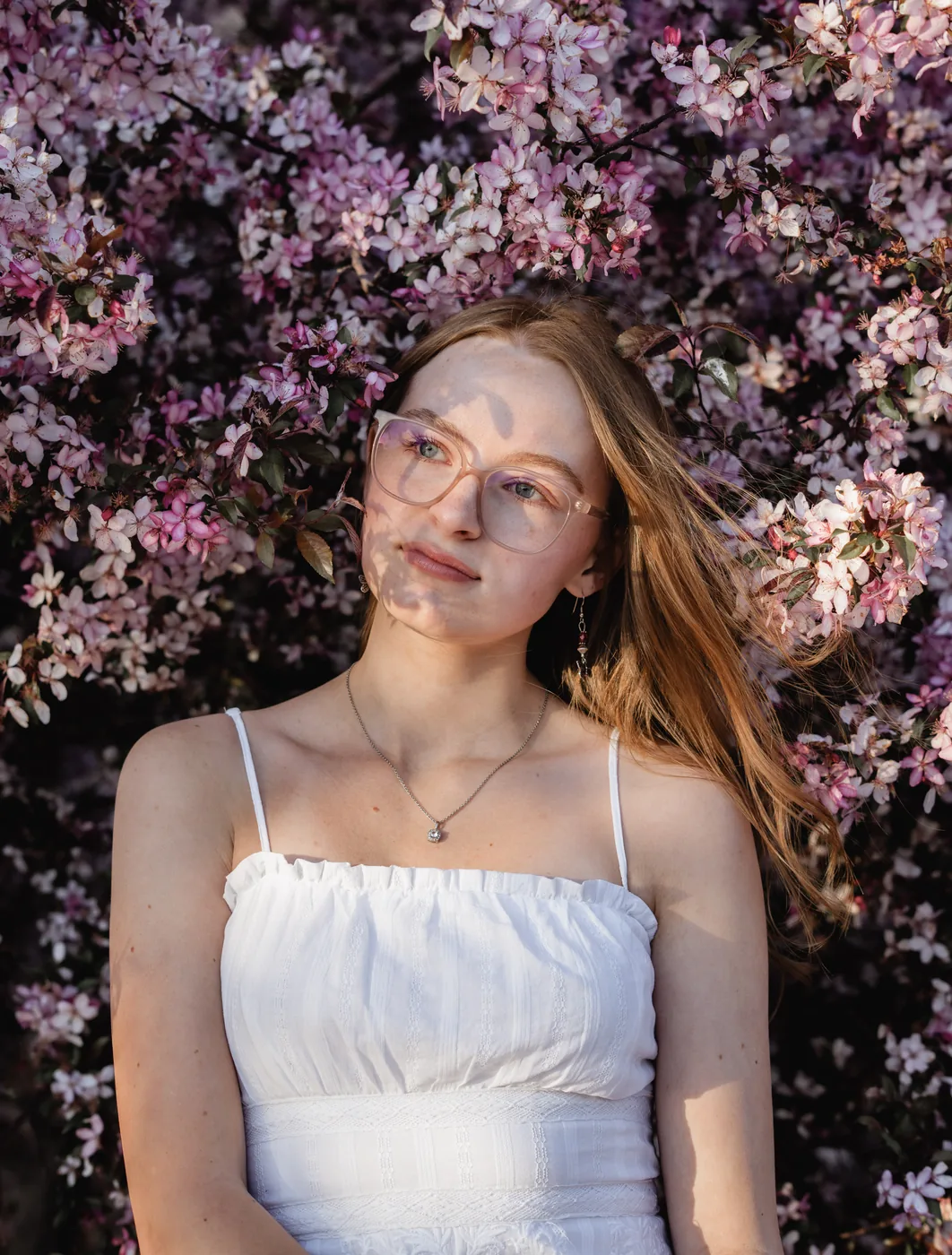 Syd Patzwald senior portrait in golden hour crabapple blossoms, Sioux Falls SD