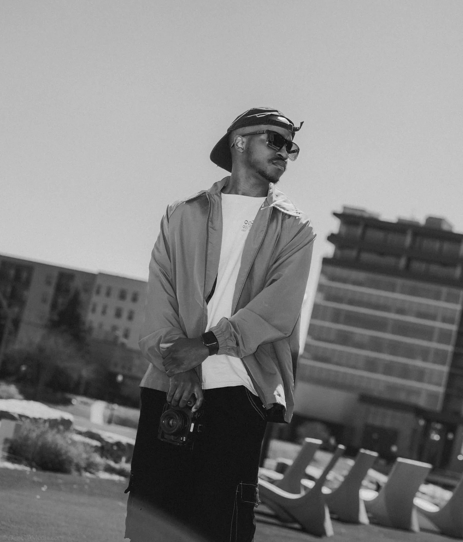 Black and white street style portrait of a man in a bucket hat