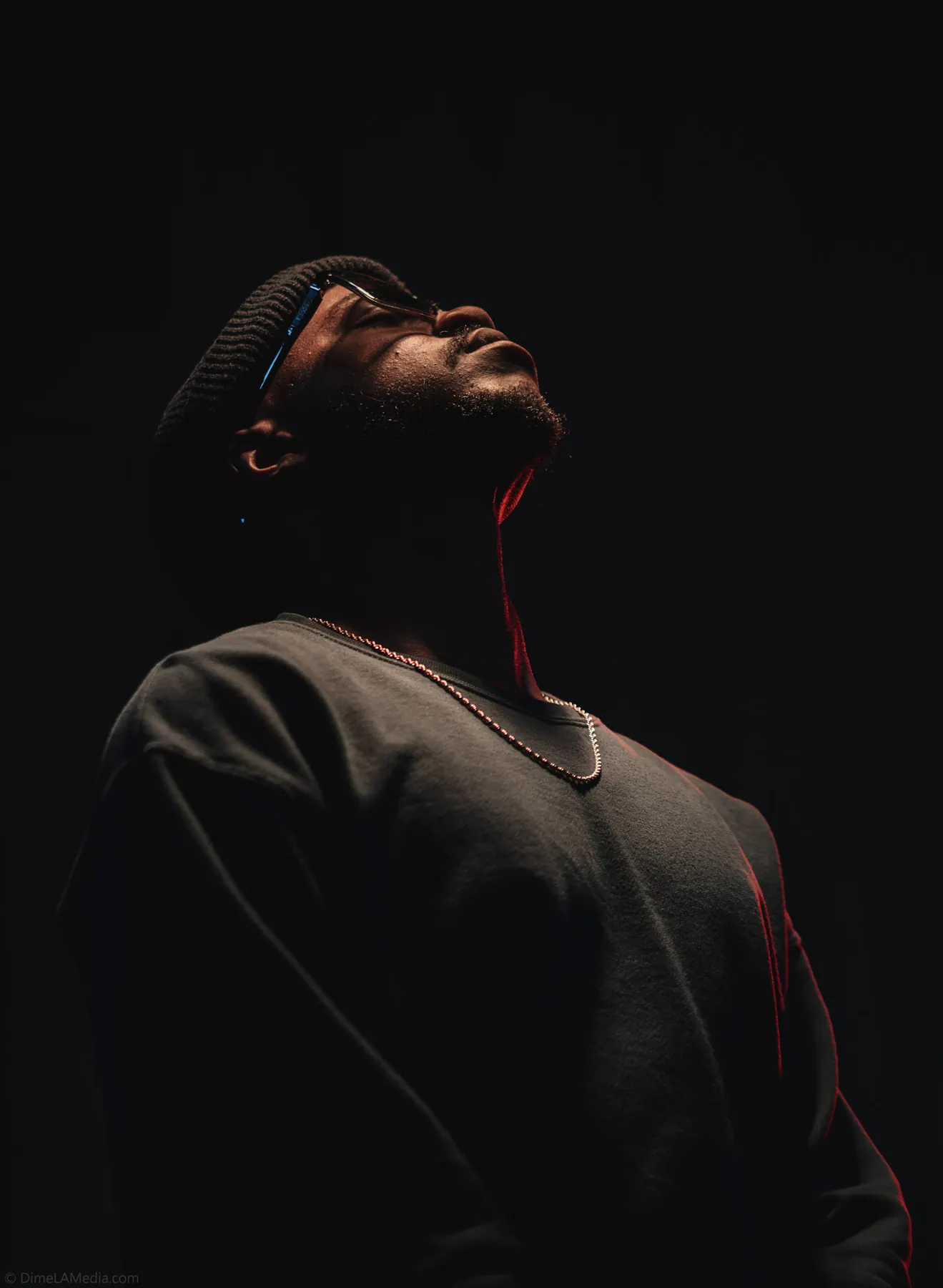 Sculpted low-key studio portrait looking upward