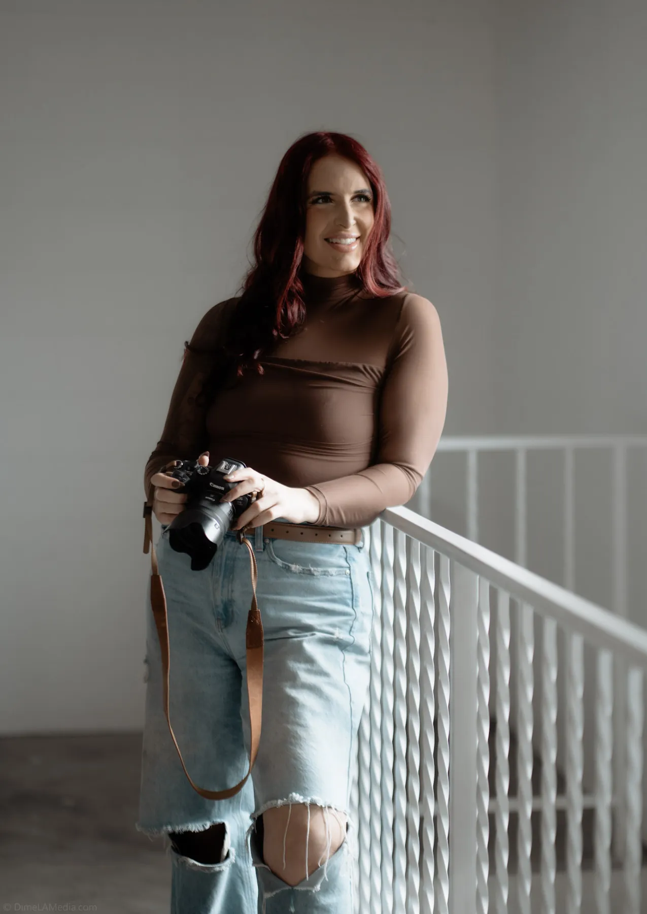 Photographer pausing between frames during a branding session