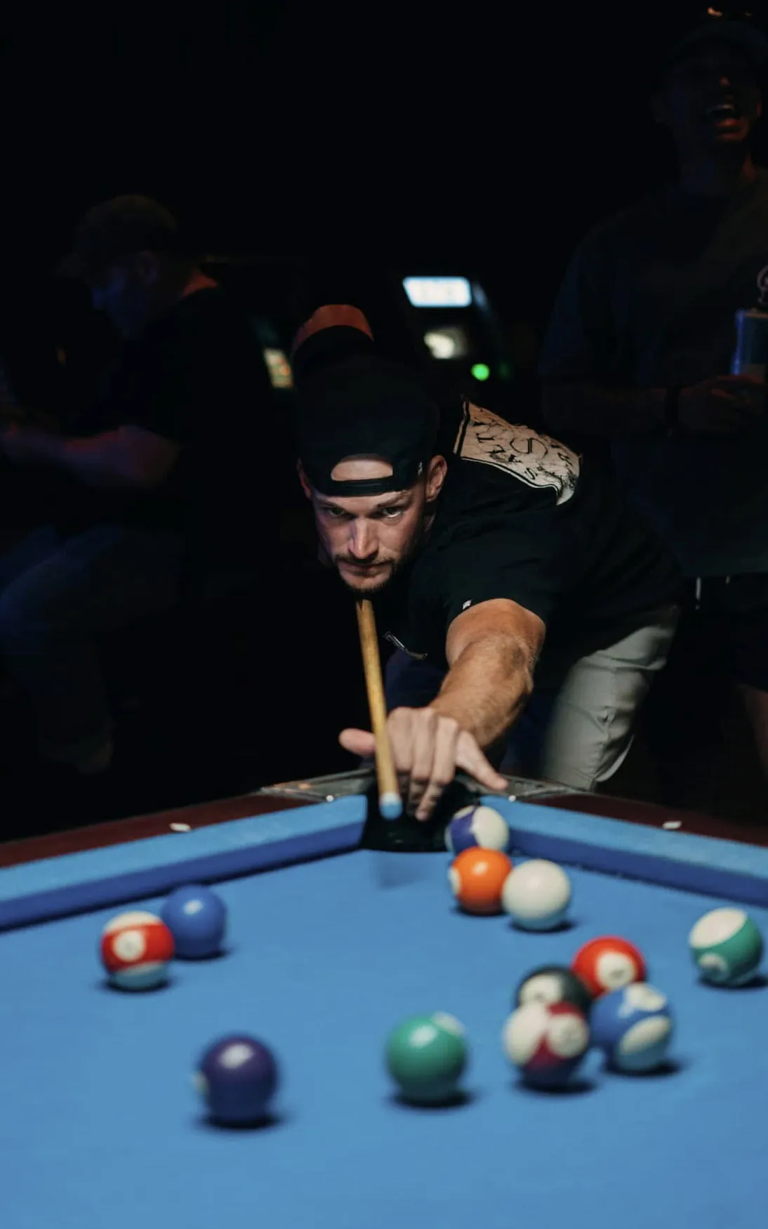 Pool hall portrait with direct eye contact down the cue