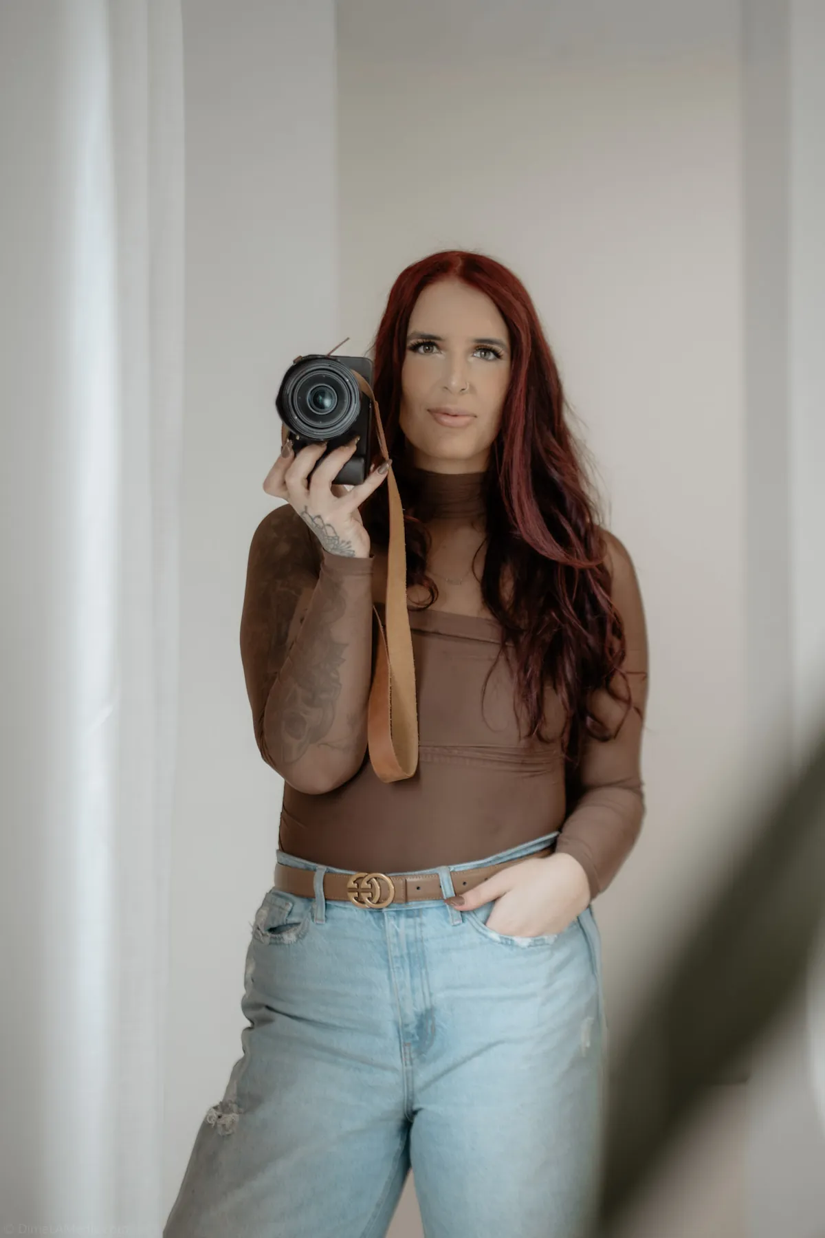 Photographer raising her camera during a personal branding session