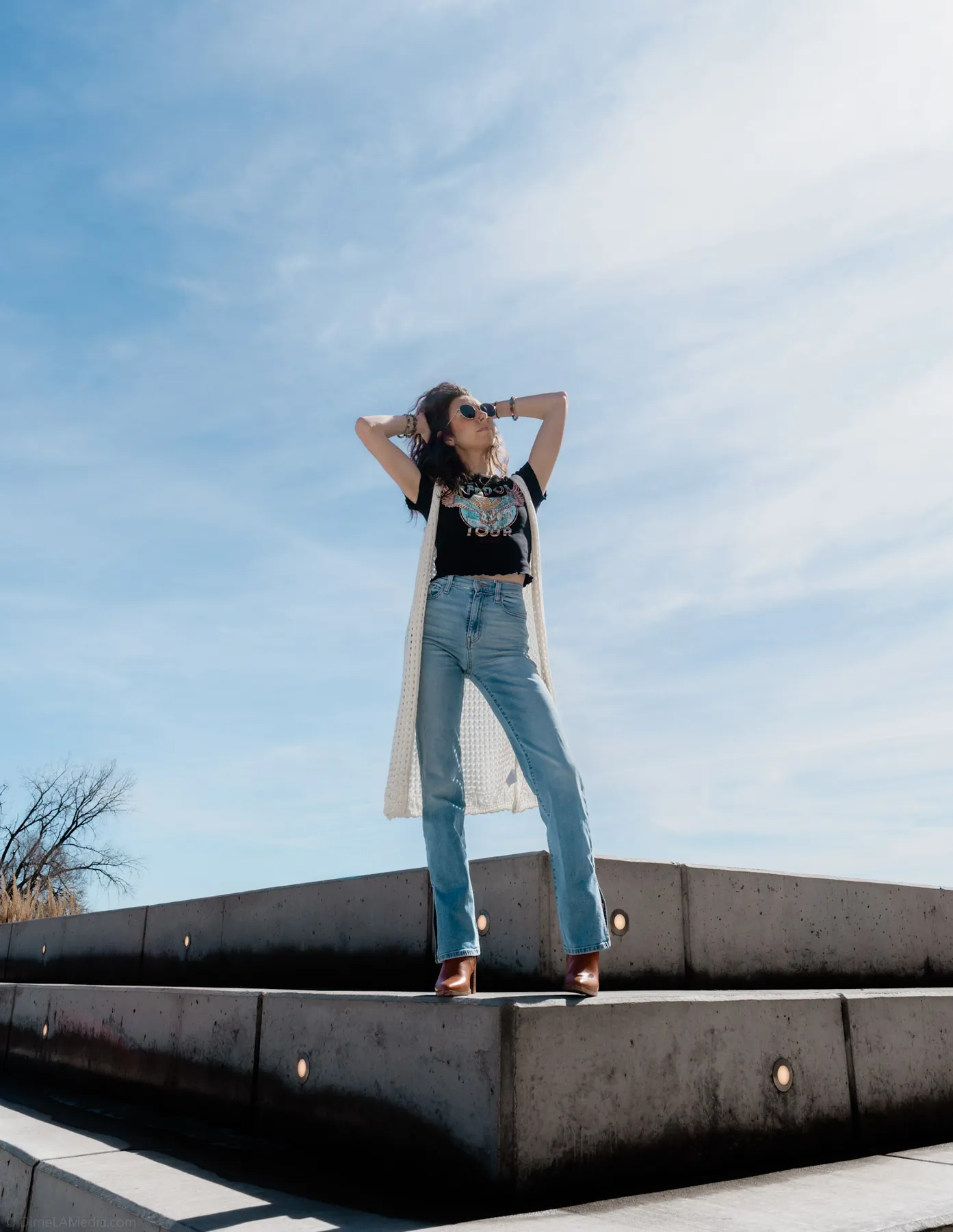 Portrait of a woman against open sky on a concrete pier