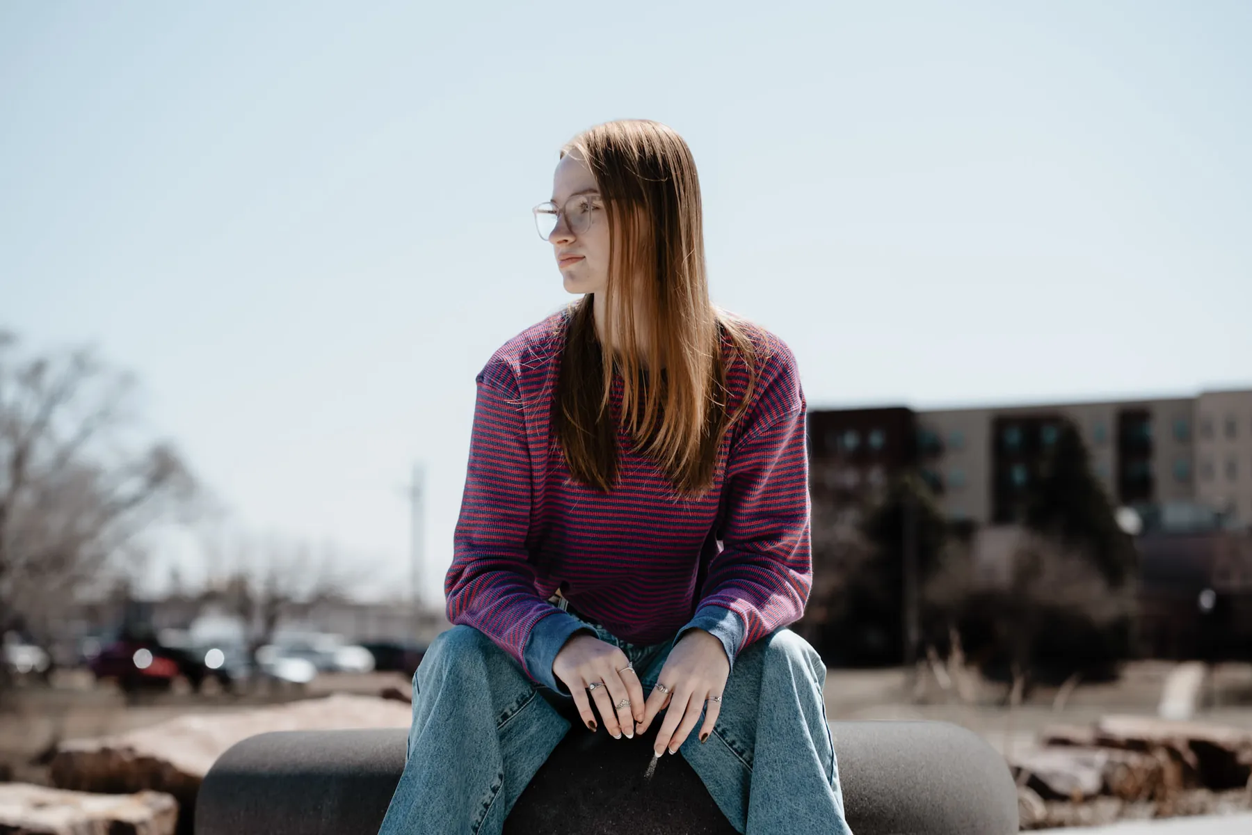 Syd Patzwald sitting on stone landscaping in downtown Sioux Falls