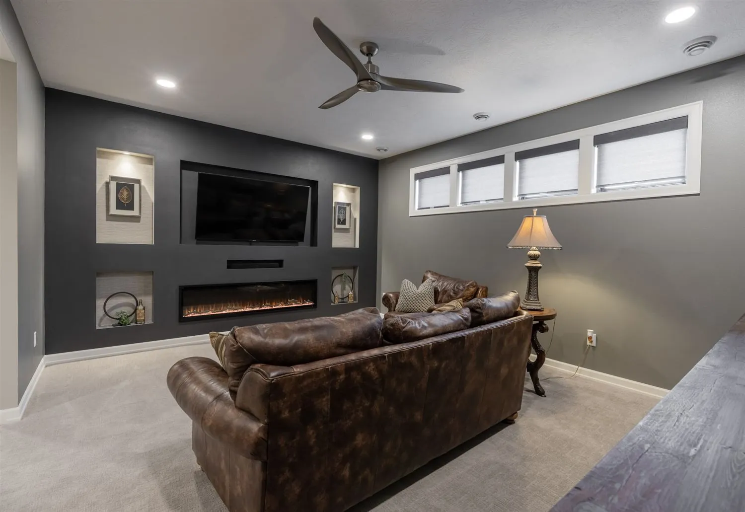 Living room with linear fireplace and dark accent wall, real estate photography Sioux Falls SD