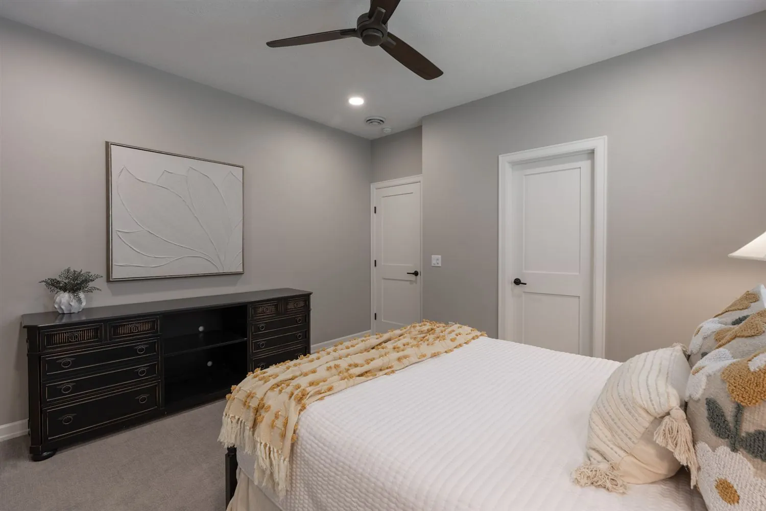 Bedroom with dark dresser and neutral tones, real estate photography Sioux Falls SD