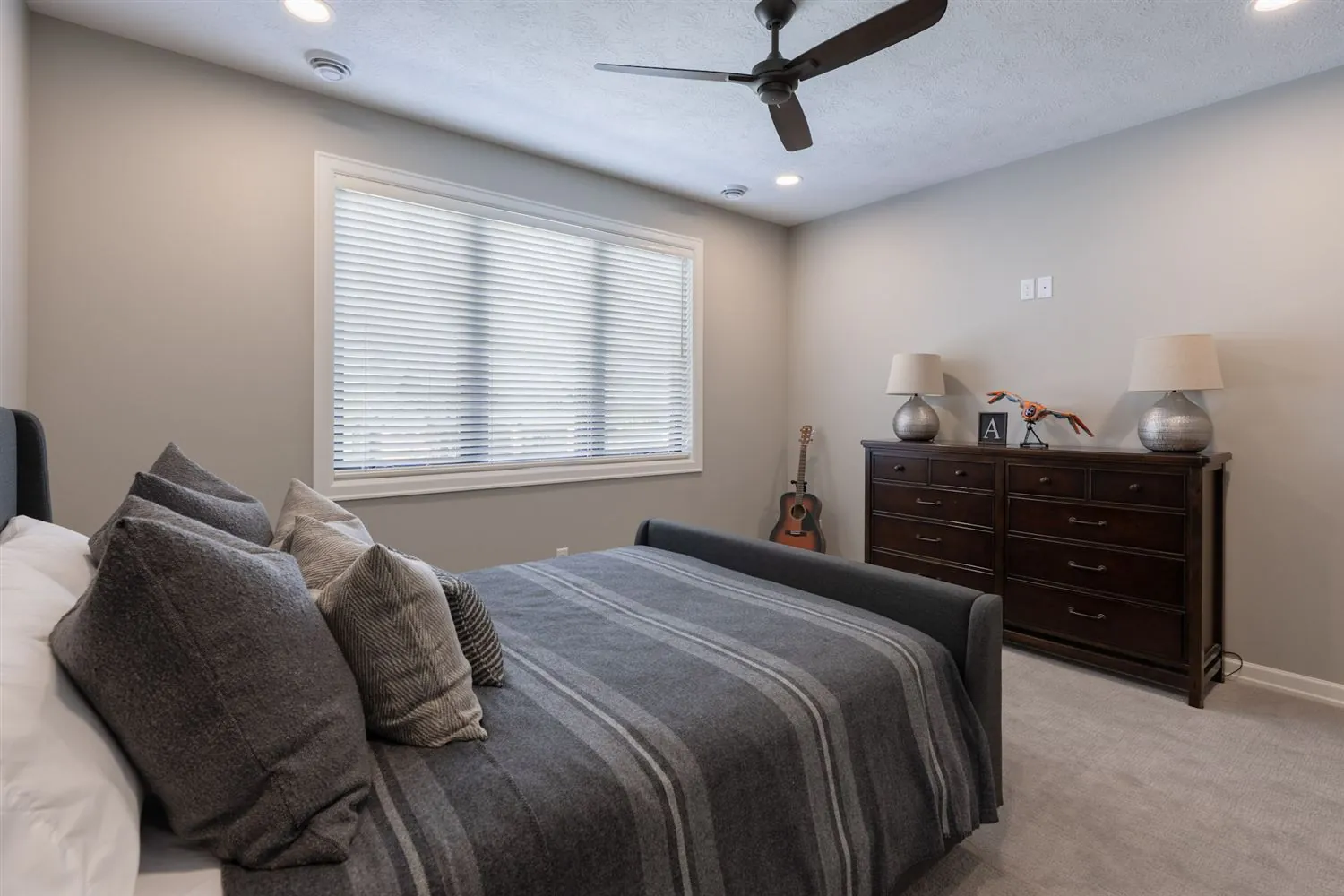 Bedroom with gray bedding and plantation shutters, real estate photography Sioux Falls SD