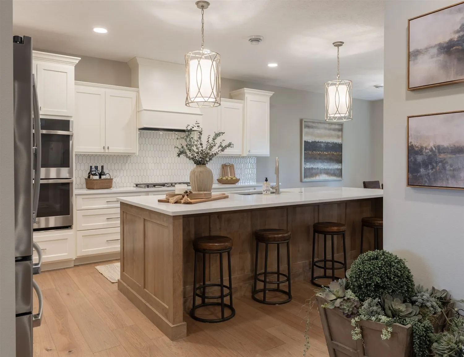 Bright white kitchen with a wood island and pendant lights, real estate photography Sioux Falls SD