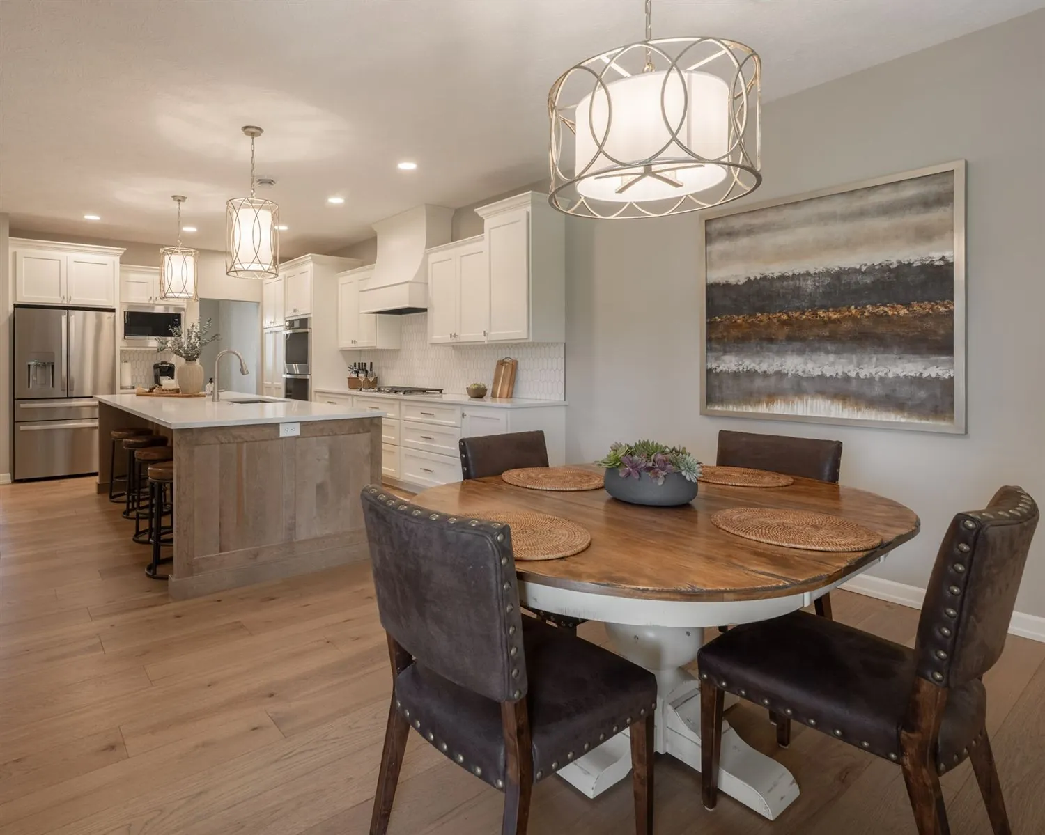Dining nook with a round table under a modern pendant, real estate photography Sioux Falls SD
