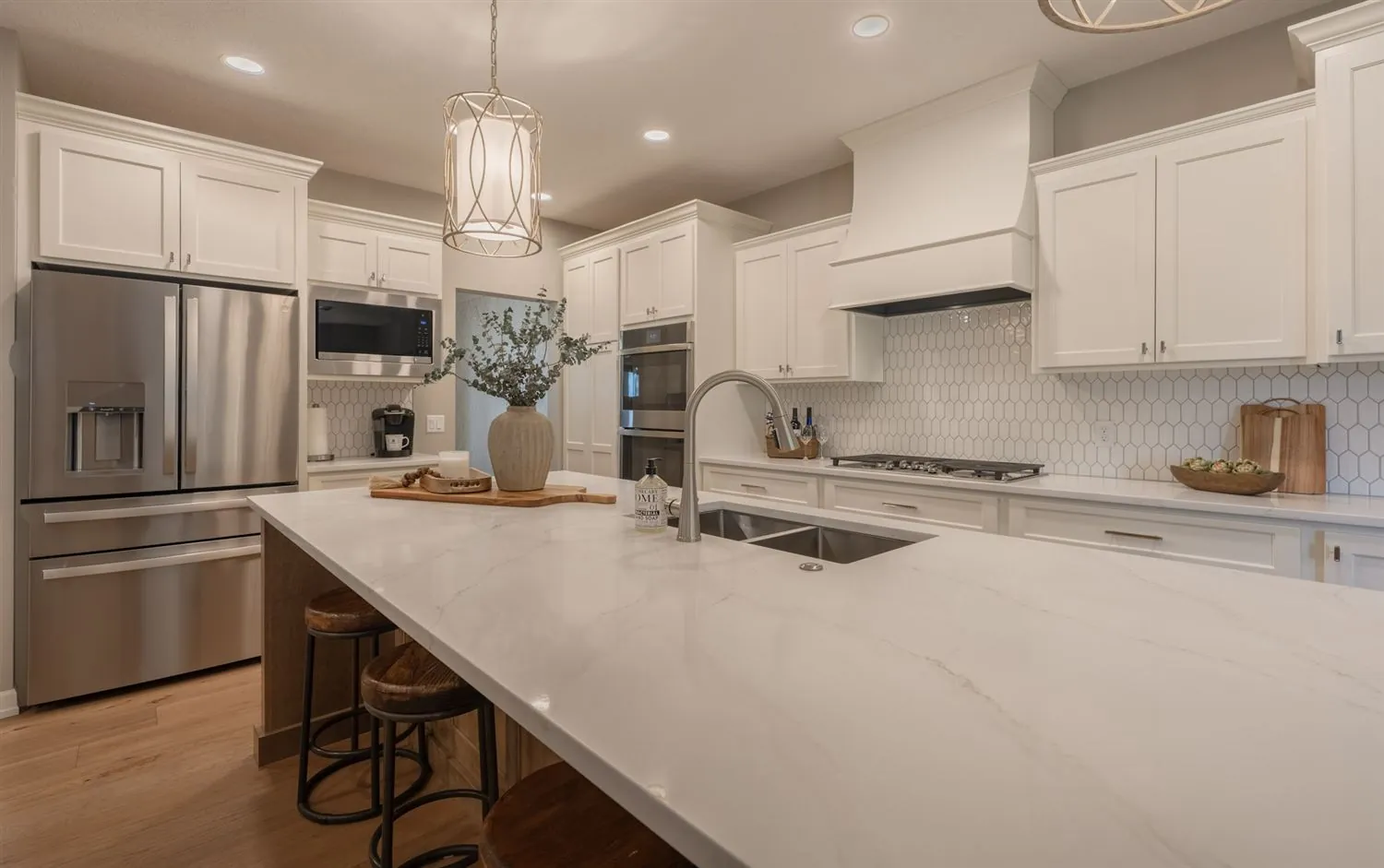 White kitchen with island seating and pendant lighting, real estate photography Sioux Falls SD
