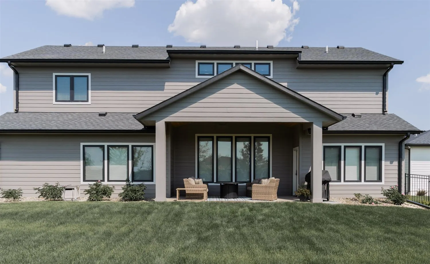 Rear exterior with covered porch and lawn, real estate photography Sioux Falls SD