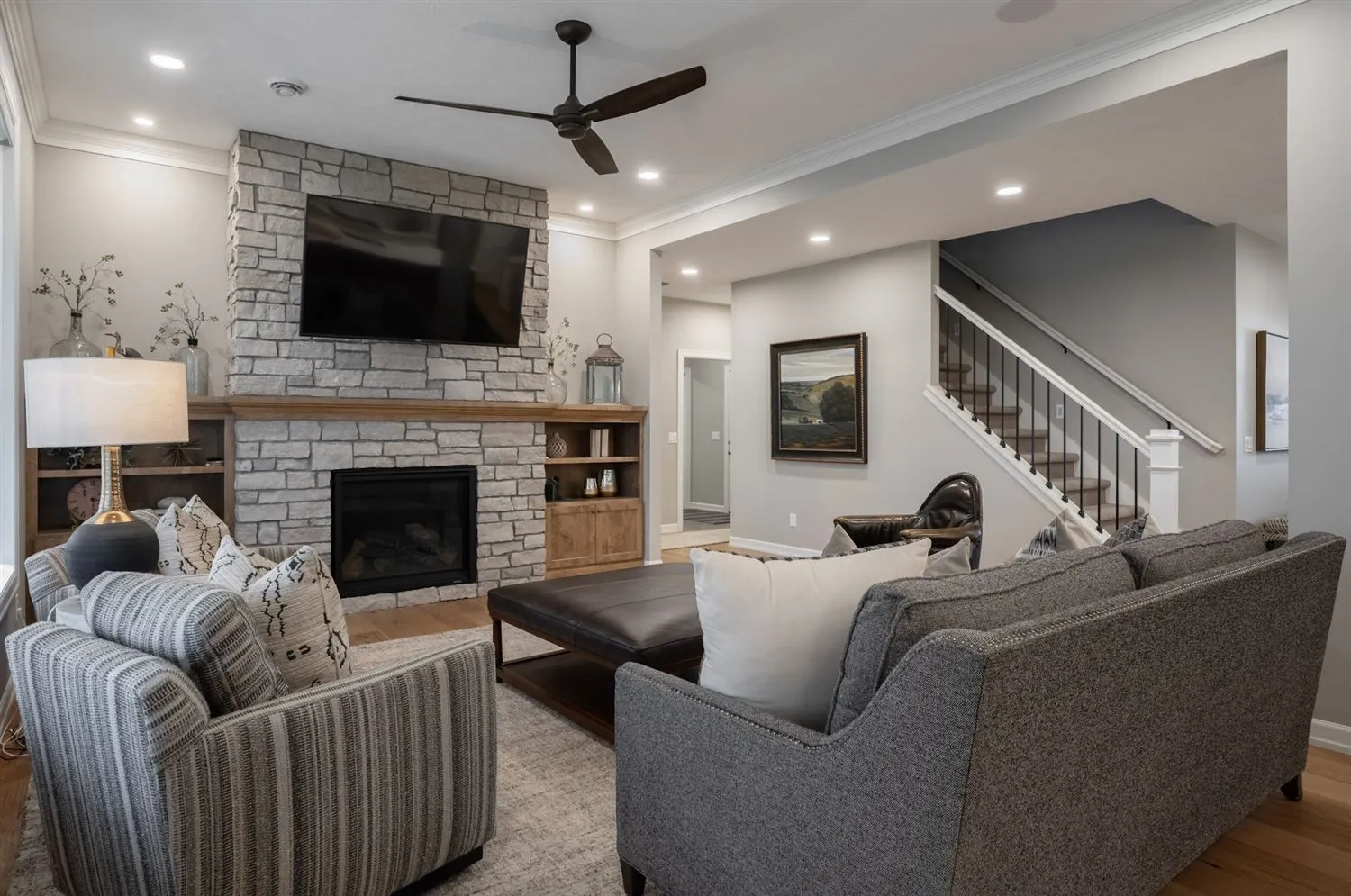 Great room with fireplace and staircase, real estate photography Sioux Falls SD