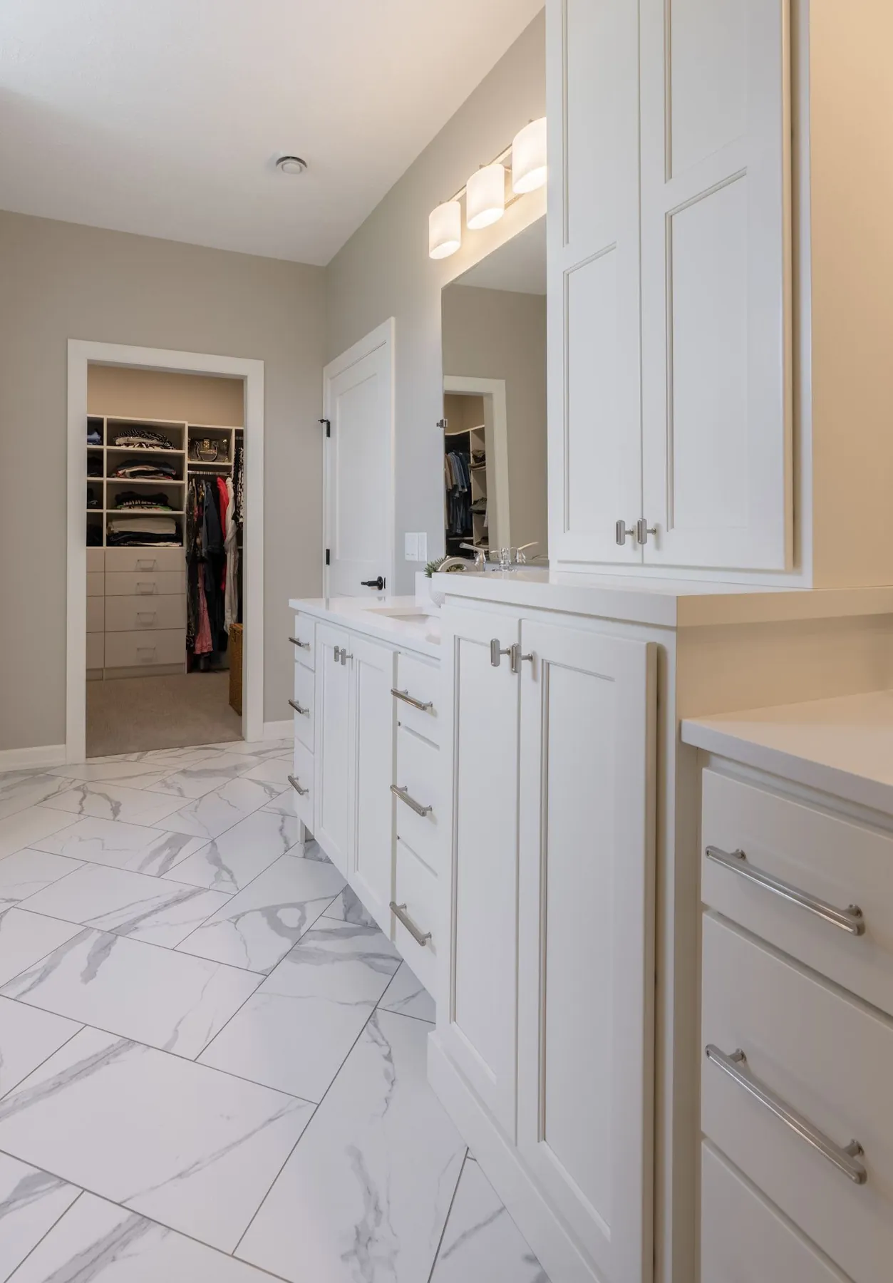 Marble bathroom with built-in cabinetry and closet, real estate photography Sioux Falls SD