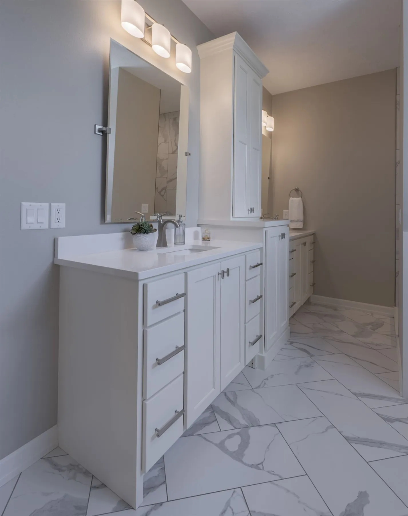 Double vanity with framed mirrors and marble floor, real estate photography Sioux Falls SD