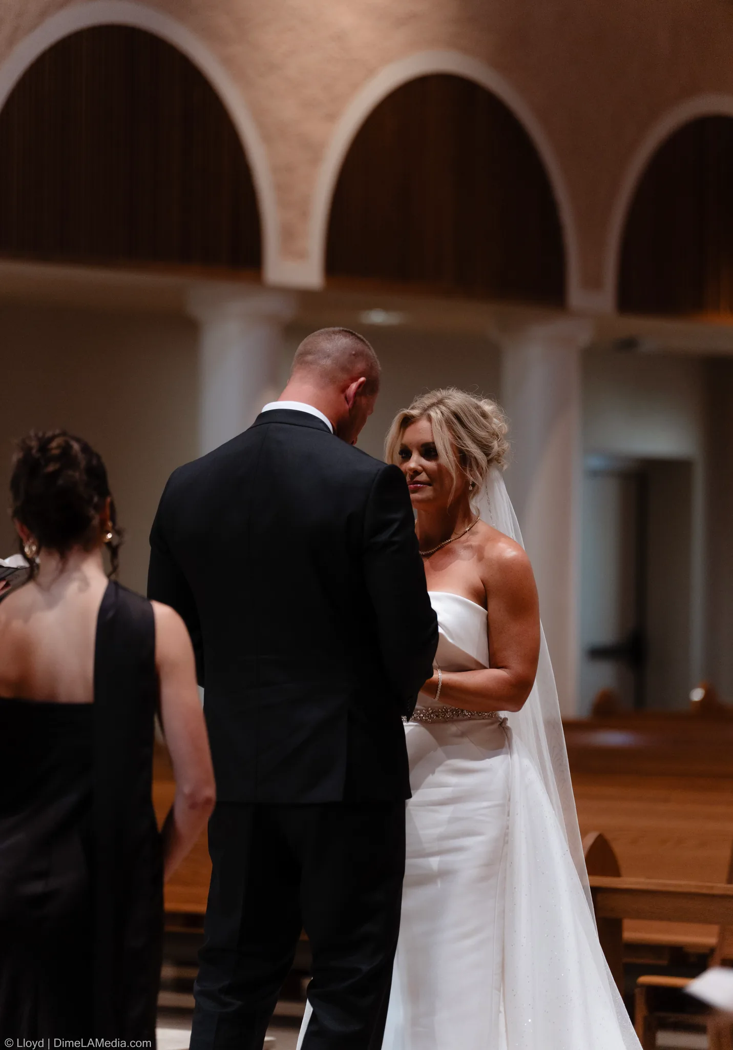 Bride smiling at her groom at the front of the church