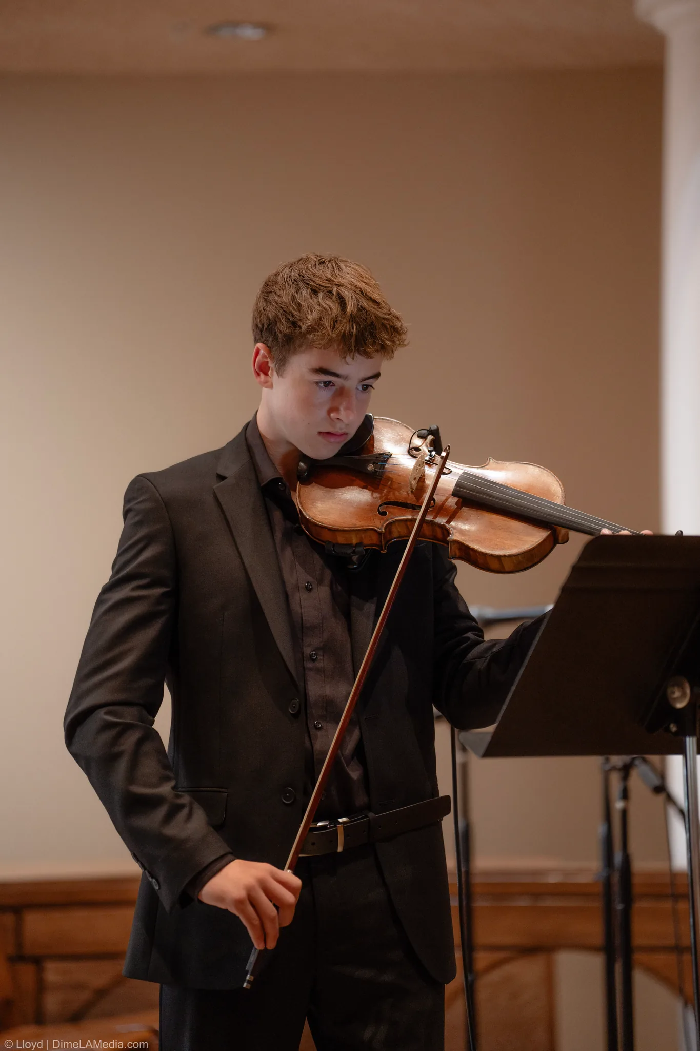 Violinist in a dark suit playing during the ceremony