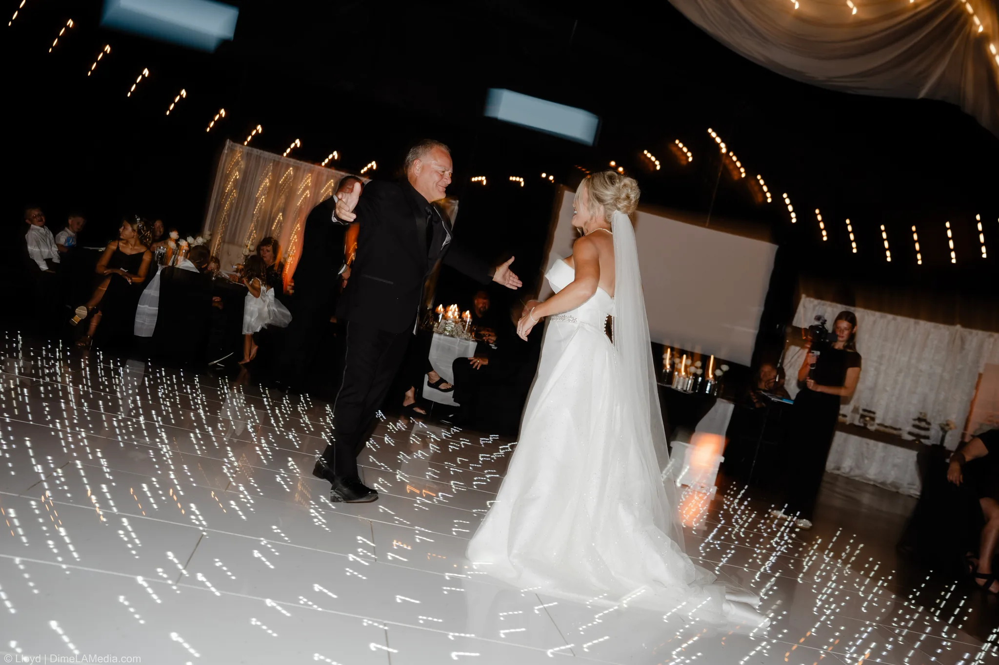 Bride dancing under string lights on a glowing dance floor, Sioux Falls SD