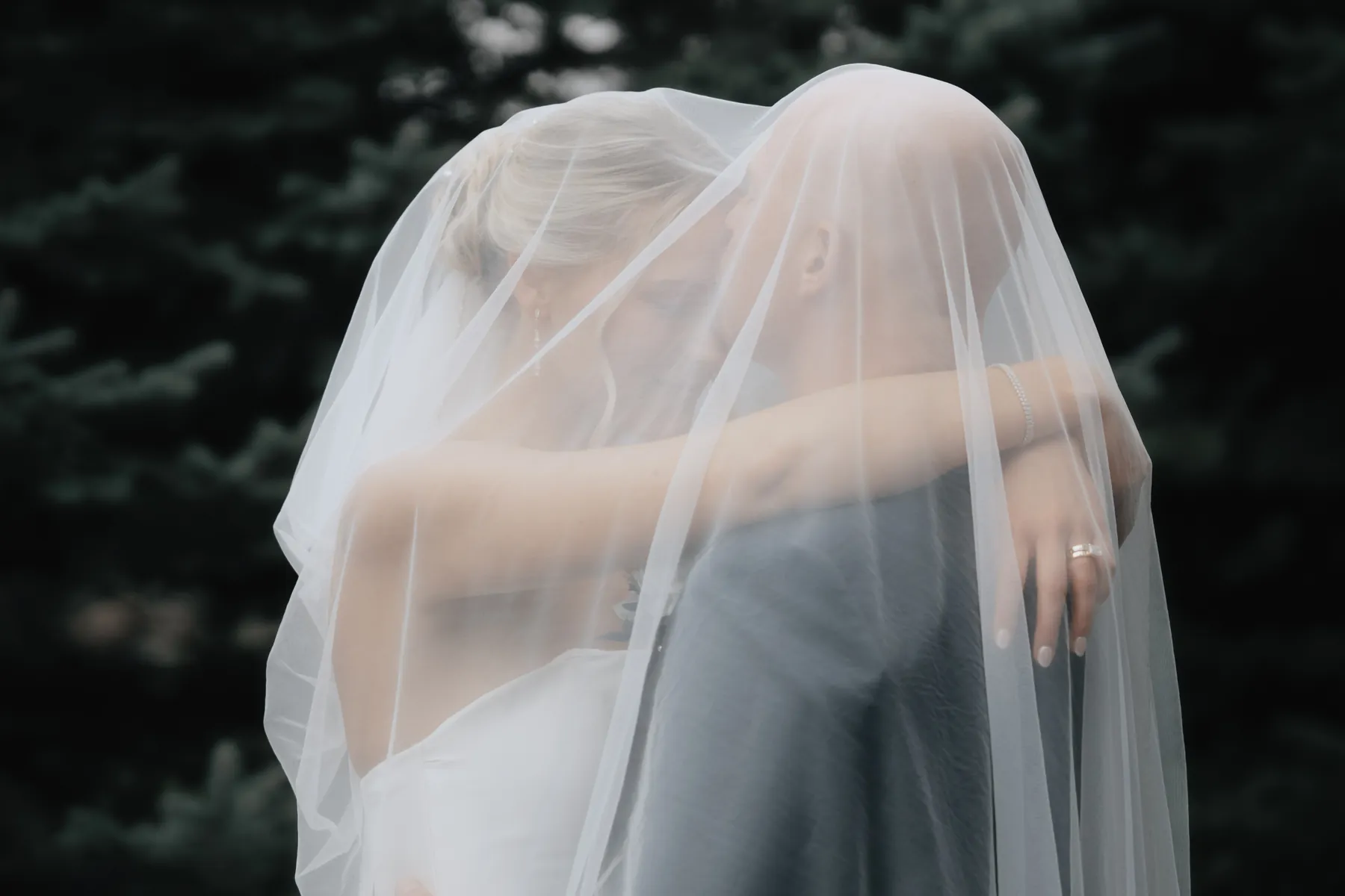 Bride and groom embracing under the veil, Sioux Falls SD