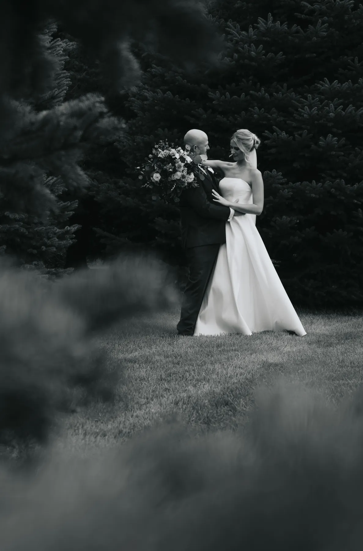 Bride and groom in the fog among dark pines, Sioux Falls SD